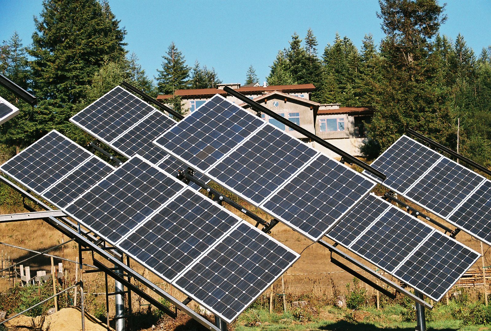 Bayside Business dual-axis solar tracker array with residence in background